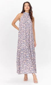 Front view of model wearing pink, polka-dotted midi dress with a halter neckline.