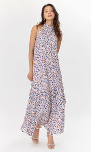 Front view of model wearing pink, polka-dotted midi dress with a halter neckline.
