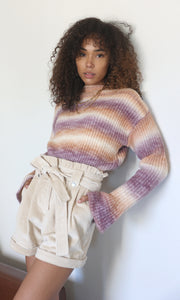 Women leaning against the wall in corduroy paper bag shorts
